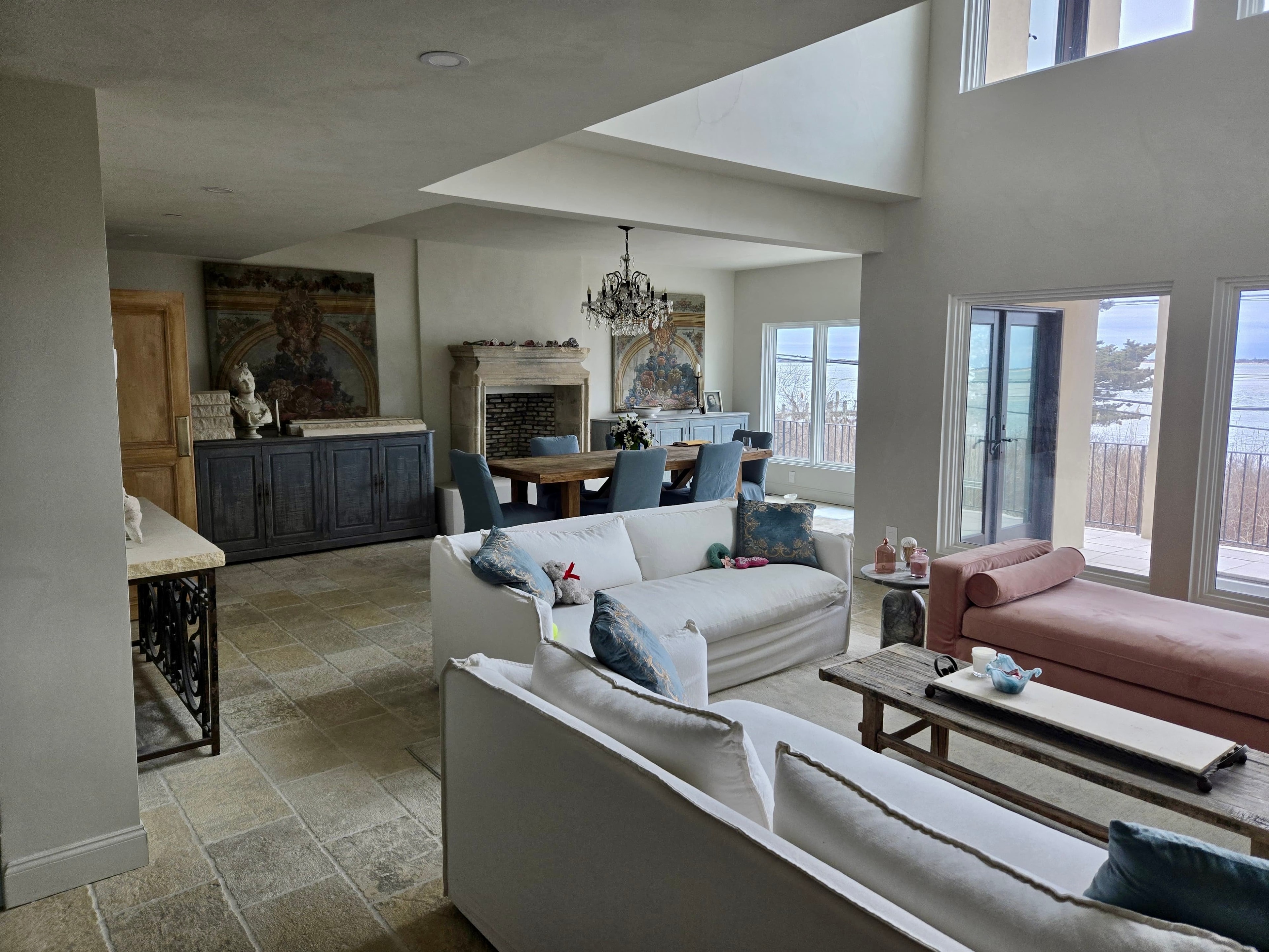 Luxury den renovation with open living area, fireplace and waterfront views