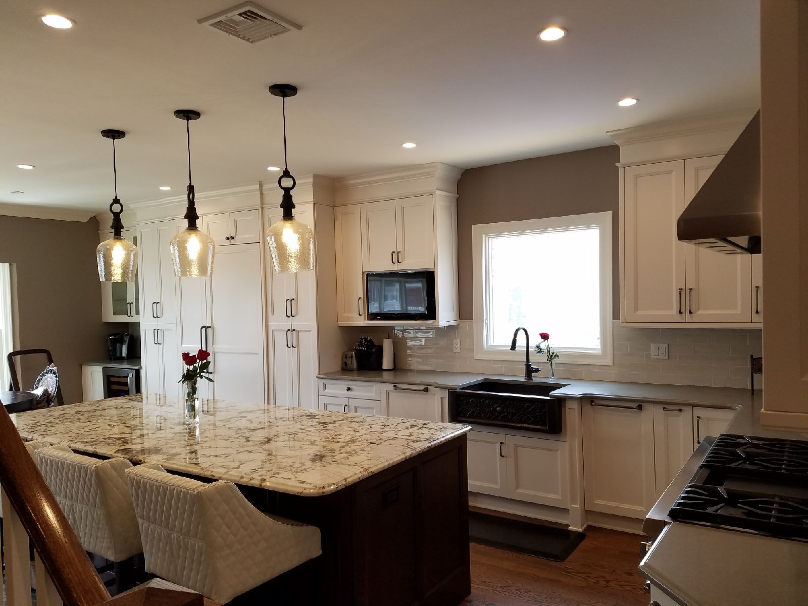 Kitchen remodel with white cabinetry and farmhouse sink